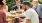 a group of people around a table with a dog