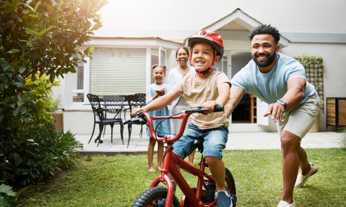 June Blog a father teaching his daughter to bike