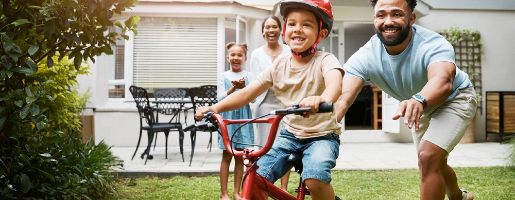 Father teaching daughter how to bike