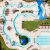 Aerial view of resort-style amenities at Alterra Sierra Vista, including a lazy river, pools, sandy beach, and sports courts in Rosharon, TX