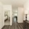 Hallway view of a modern home at Alterra Sierra Vista in Rosharon, TX, featuring wood flooring, bedroom, and dining area.