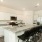 3 Bedroom single family homes for rent in Rosharon TX - Alterra at Sierra Vista - Modern Kitchen with Stainless Steel Appliances, Granite Countertops, and a Large Cooking Island with Chairs