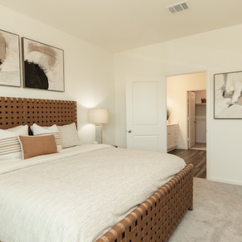 3 Bedroom Homes for rent in Rosharon TX - Alterra at Sierra Vista - Carpeted Bedroom with White Walls, a Large Bed, Nightstands, and an Attached Bathroom